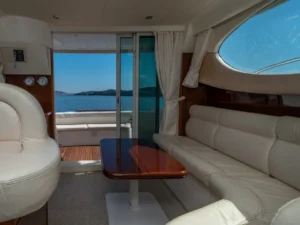 Interior saloon with seating and dining table on the Jeanneau Prestige 32 motor yacht