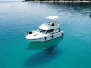 Jeanneau Prestige 32 motor yacht anchored in clear turquoise water during a private boat tour from Split