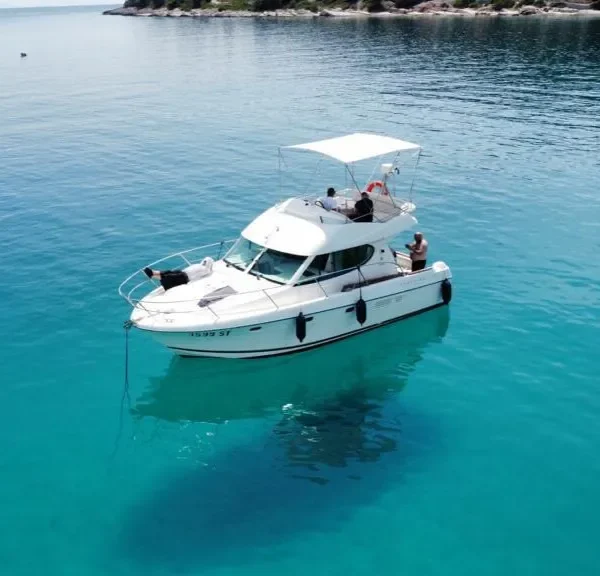 Jeanneau Prestige 32 motor yacht anchored in clear turquoise water during a private boat tour from Split