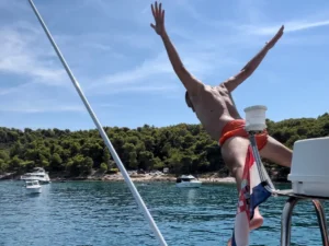 Guest jumping into the sea during a private boat tour in Split, Croatia