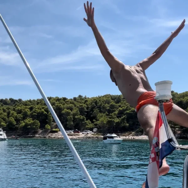 Guest jumping into the sea during a private boat tour in Split, Croatia
