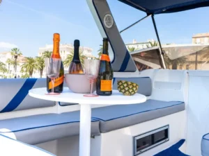 Onboard seating area with drinks and champagne on the Saver Riviera 24 during a private boat tour from Split