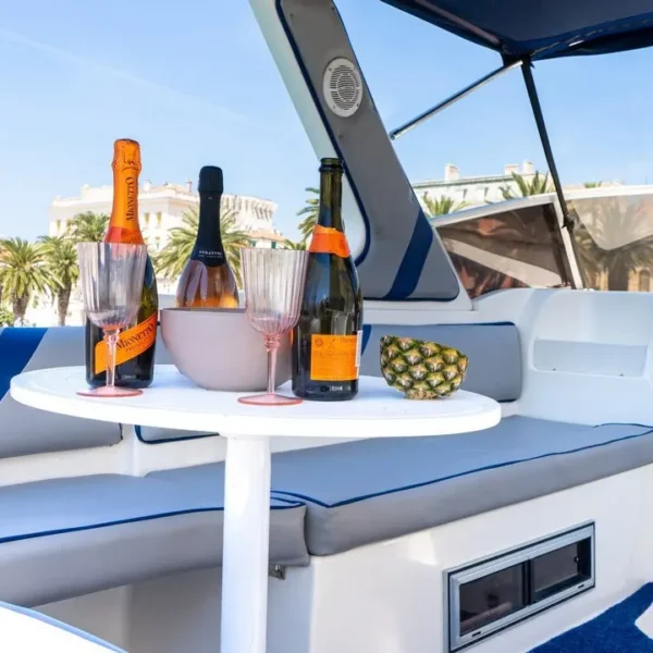 Onboard seating area with drinks and champagne on the Saver Riviera 24 during a private boat tour from Split