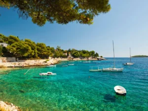 Anchored boats in crystal clear Adriatic Sea on Adriatic Escape tour