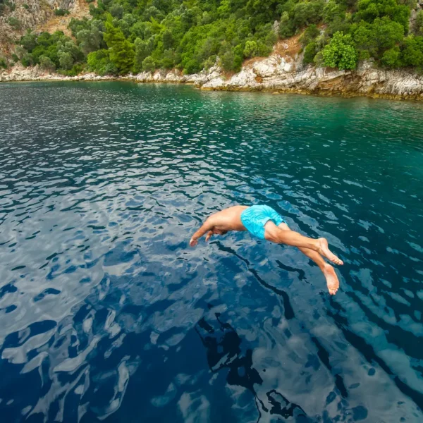 Guest jumping into the crystal clear Adriatic Sea from the boat