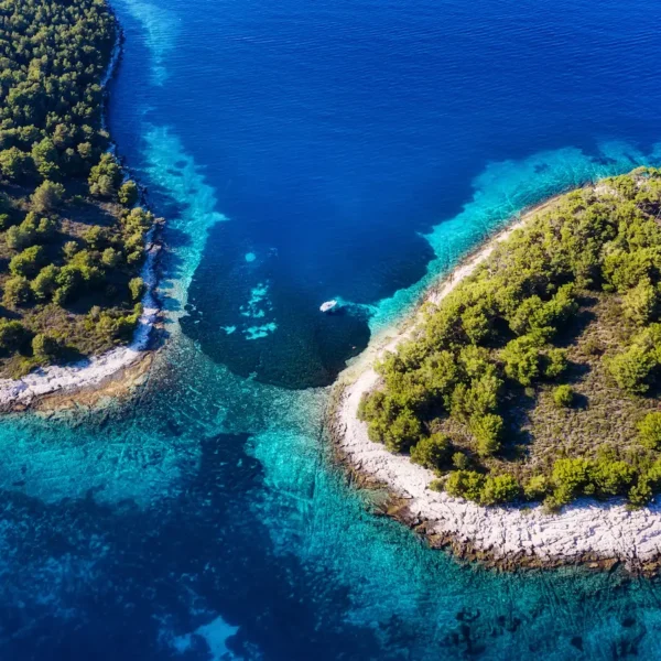 Aerial view of a small Adriatic island with crystal clear water in Croatia