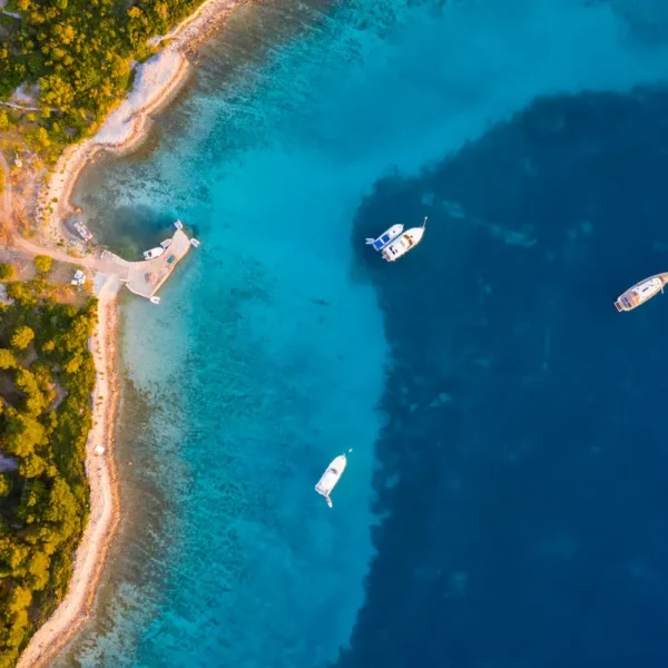 Aerial view of boats anchored in a turquoise Adriatic bay in Croatia