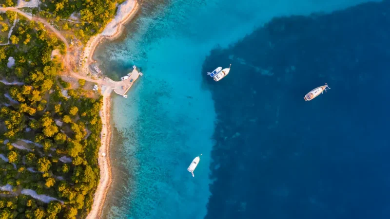 Aerial view of boats anchored in a turquoise Adriatic bay in Croatia