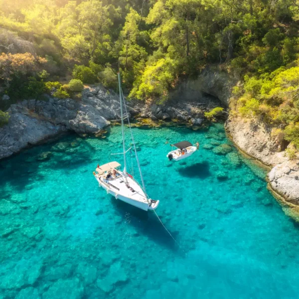 Hidden bay with crystal clear turquoise sea and boats anchored during Adriatic Escape private boat tour