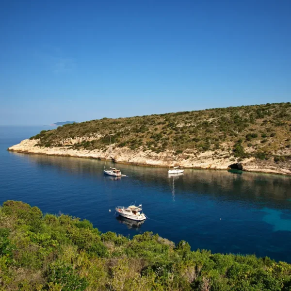 Hidden bay near Brač island with anchored boats during the Dalmatian Drift tour