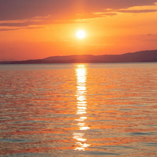 Sunset over the Adriatic Sea during a private boat tour from Split with golden reflections on calm water