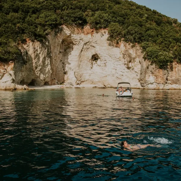 Guests swimming in a secluded Adriatic bay near rocky cliffs in Croatia
