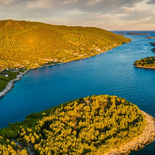 Aerial view of a scenic bay near Hvar island with turquoise water and small islands during sunset in the Adriatic Sea